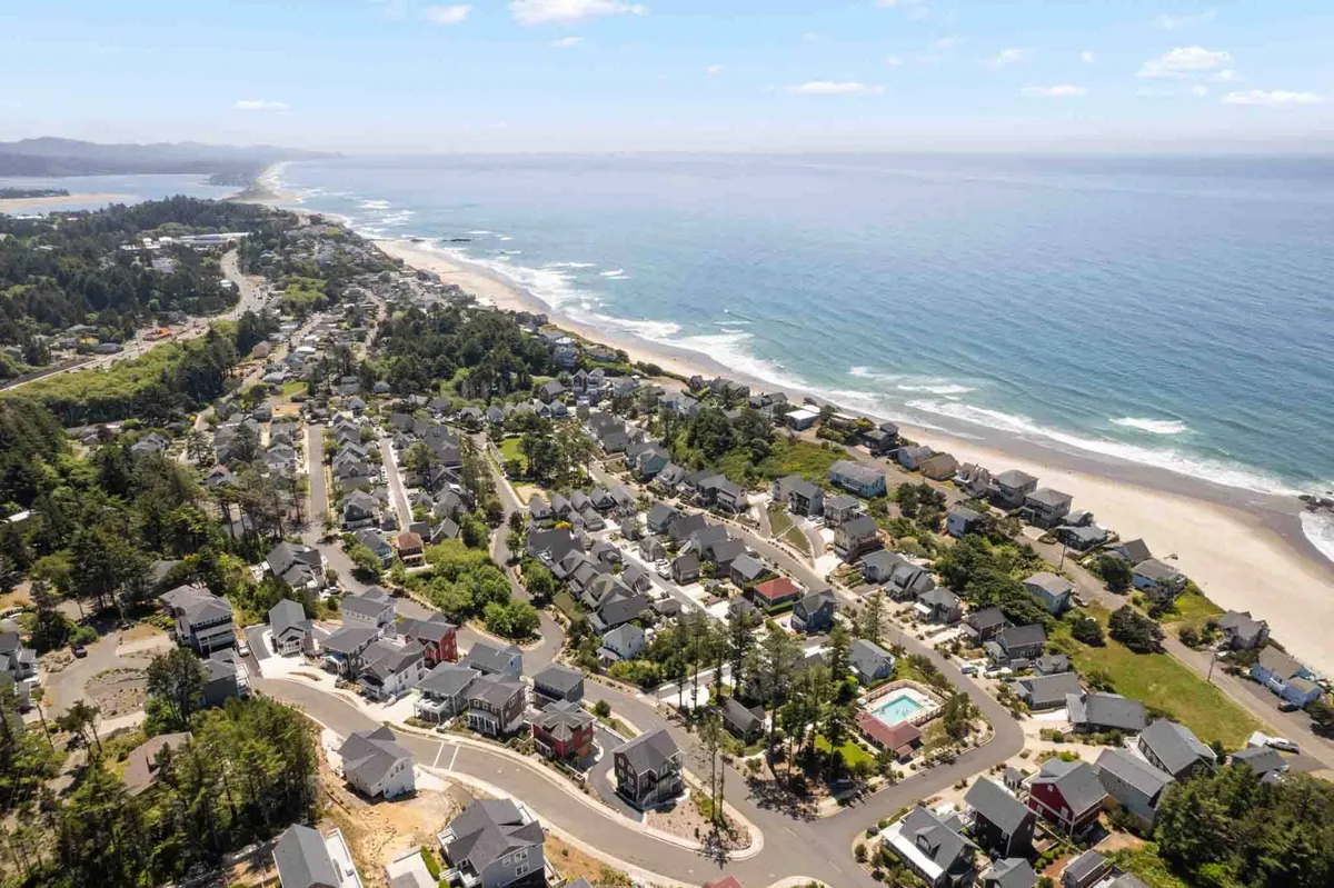 A stunning coastal view captures ocean waves, the neighborhood layout, and gathering spots along the shore. This image evokes relaxation, adventure, and the vibrant local culture that guests can experience just moments from Casa de la Madre.